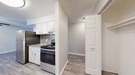 Located at 9440 Hoffman Way in Thornton, CO, this two-bedroom, one-bathroom single-floor home offers a thoughtfully organized layout across a comfortable footprint. The galley-style kitchen is a standout feature, showcasing white cabinetry with modern hardware, granite-look countertops, a mosaic tile backsplash, and a full suite of stainless steel appliances including a refrigerator, range, and dishwasher. Light-toned luxury vinyl plank flooring runs through the kitchen, living room, dining room, and hallway, lending a clean, contemporary feel throughout the shared spaces. The living room receives natural light through a window fitted with horizontal blinds and includes baseboard heating and a wall-mounted air conditioning unit. Both bedrooms are carpeted and offer a warm, quiet retreat. The primary bedroom features a ceiling fan, baseboard heating, and a mirrored sliding-door closet. The second bedroom also includes baseboard heating, a natural light window, and access to a dedicated closet. The full bathroom is finished with LVP flooring, a soaking tub with shower, a curved curtain rod, and a speckled vanity countertop. Four closets throughout the home provide generous storage. Textured ceilings are present throughout, adding a classic residential character to the space.