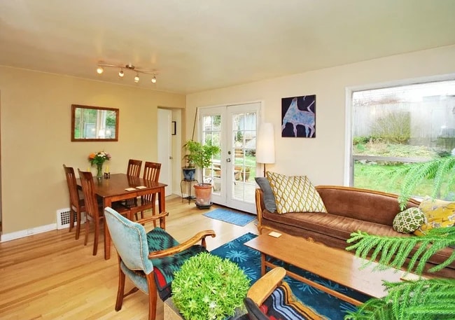 Living room and dining area. Unit is no longer furnished. - 4222 4th Ave NW