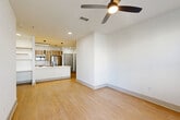 Located at 747 Ralph McGill Blvd NE in Atlanta's vibrant Old Fourth Ward neighborhood, this well-appointed 2-bedroom, 2-bathroom residence offers a thoughtfully designed single-floor layout. The open-concept living and kitchen area serves as the heart of the home, featuring warm wood-tone cabinetry, a crisp white quartz island with an undermount sink and stainless steel dishwasher, a subway tile backsplash, and stainless steel appliances including a French door refrigerator, electric range, and over-the-range microwave. Sleek pendant lighting accents the island, adding a modern touch. Light wood-style flooring flows throughout the unit, complemented by clean white walls and a ceiling fan in the living area. Both bedrooms are bright and airy, benefiting from large windows with views of surrounding greenery and ceiling fans for added comfort. The primary bedroom includes access to a well-proportioned en-suite bathroom with a wood-tone double vanity, white countertops, and a large mirror with contemporary lighting, which connects directly to a walk-in closet with wire shelving. Additional storage is provided through multiple closets, a pantry, laundry, and a utility room, ensuring exceptional functionality throughout.