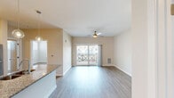 Located at 719 Lantern Walk Dr in Little River, SC, this well-appointed one-bedroom, one-bathroom residence offers a modern and cohesive interior design throughout its single-story layout. Light-toned luxury vinyl plank flooring flows seamlessly across every room, creating a clean and consistent aesthetic.

The open kitchen and living area serve as the heart of the home. The kitchen is outfitted with crisp white shaker-style cabinetry, granite countertops, a peninsula with an undermount sink, and a full suite of stainless steel appliances including a range, microwave, and refrigerator. Globe pendant lights hang above the peninsula, adding a stylish finishing touch.

The spacious living room features a ceiling fan and connects to a private balcony through sliding glass doors, bringing in natural light and outdoor views of the surrounding neighborhood.

The bedroom is a well-proportioned retreat featuring large windows that invite abundant natural light, a ceiling fan, and a closet with panel doors. The full bathroom includes white cabinetry, granite countertops, a tub-shower combination, and a generous vanity area. A utility room completes the layout, adding practical everyday functionality to this efficiently designed residence.