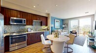 Located at 4108 Del Rey Ave in Marina del Rey, this well-appointed one-bedroom, one-bathroom residence offers a thoughtfully designed open-concept floor plan with warm wood flooring flowing throughout. The kitchen is a standout feature, showcasing rich dark-wood cabinetry extending to the ceiling, a mosaic tile backsplash, granite countertops, and a full suite of stainless steel appliances including a gas range, built-in microwave, dishwasher, and french-door refrigerator. A round marble-topped dining table nestled adjacent to the kitchen creates a seamless transition into the living area. The bright living room is anchored by a bold accent wall and floor-to-ceiling sliding glass doors that open onto a private balcony, offering sweeping views of the Marina del Rey skyline and surrounding neighborhood under the Southern California sun. The spacious bedroom features warm neutral tones, hardwood-style flooring, and a generous window that fills the room with natural light. A dedicated closet provides ample storage. The bathroom is finished with a wood-vanity, granite countertop, framed mirrors, and coordinating blue accent walls, lending a cohesive and polished aesthetic. Recessed lighting and a clean, modern palette complete this refined coastal residence.