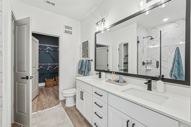 Bathroom with Quartz Countertops, Double Vanity Sinks, Walk-in Shower, and Walk-in Closet - Forayna Watercolor Place