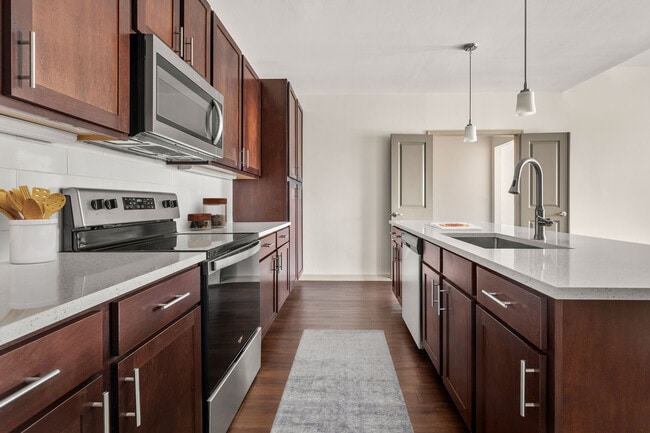 Create meals and memories in your modern kitchen. - Aster at Lely Resort