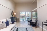 Located at 1050 Summerside Dr in San Jose, CA, this two-bedroom, two-bathroom residence offers a well-designed single-floor layout with a range of notable architectural features. The living room makes an immediate impression with its soaring vaulted ceilings and light-toned hardwood-style flooring, creating an open and airy atmosphere. Sliding glass doors lead directly to one of two balconies, both of which overlook a resort-style pool area surrounded by tall palm trees — a standout feature of this home.

The dining area is positioned adjacent to the kitchen and benefits from a large window framing the same lush poolside views, filling the space with natural light. The galley-style kitchen features warm wood cabinetry, laminate countertops, a stainless steel sink, and white appliances, with access to the hallway connecting the rest of the home.

Both bedrooms are carpeted and comfortably sized, with the primary bedroom offering a spacious closet and easy access to one of the two bathrooms. The second bedroom features a textured ceiling and a bright window. Each bathroom is clean and functional, with one featuring a glass-enclosed walk-in shower and wood-toned vanity. Three closets throughout the unit provide ample storage. The layout also includes a dedicated hallway connecting all areas of the home efficiently.