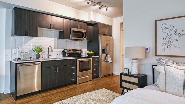 Griffis Shoreline kitchen with wood style floor. - Griffis Shoreline