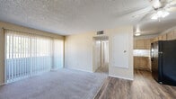 Located at 121 Kokomo St in Colorado Springs, Colorado, this single-floor, 3-bedroom, 1-bathroom home offers a practical and efficiently arranged layout. The living room serves as the central gathering space, featuring a combination of carpet and wood-look flooring, warm neutral-toned walls, a textured ceiling, and a ceiling fan. It flows openly toward the kitchen, which is equipped with light wood cabinetry, white countertops, a stainless sink, and black appliances including a refrigerator and dishwasher, all set atop wood-look flooring. The three bedrooms are carpeted throughout and bathed in natural light from windows fitted with vertical blinds. Each bedroom features neutral walls and a textured ceiling, with select rooms offering built-in bifold closets for ample storage. The primary bedroom provides a comfortable, well-proportioned retreat. The shared full bathroom includes a tub-shower combination, a toilet, and warm wood-look flooring, presenting a clean and functional design. A central hallway connects all rooms efficiently. Textured ceilings are consistent throughout the home, adding a classic touch to the overall interior character.