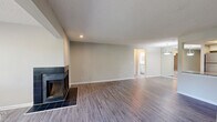 Located in Brookhaven, Georgia, this single-floor, 2-bedroom, 3-bathroom residence offers a well-organized and functional layout. The open living and dining area is a standout feature, showcasing durable wood-look flooring, neutral-toned walls, a textured ceiling, and a striking black-tiled fireplace that anchors the room. Large windows allow natural light to fill the space, creating a bright and welcoming atmosphere.

The kitchen is efficiently designed in a galley style, featuring white cabinetry with modern hardware, granite-look countertops, a tile backsplash, and black stainless appliances including a range, microwave, and dishwasher. A dedicated laundry room is conveniently accessible from the kitchen and includes a full-size washer and dryer with additional storage shelving.

The primary bedroom offers generous proportions, plush carpeting, a ceiling fan with light fixture, and a window with outdoor views of greenery. Additional bedrooms are similarly carpeted and well-lit. The bathrooms are finished with white cabinetry, granite-look countertops, and clean tub/shower combinations. Two closets provide ample storage throughout. The overall ambiance is clean, neutral, and move-in ready.