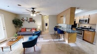 Located at 505 Fox Crossing Blvd in Knoxville, Tennessee, this well-appointed 2-bedroom, 2-bathroom residence delivers a comfortable and cohesive single-floor layout. The open-concept living and kitchen area serves as the heart of the home, featuring a cozy fireplace flanked by a wall-mounted TV nook and French doors that bring in natural light while offering outdoor access. Ceiling fans throughout aid airflow and add a classic touch. The kitchen is outfitted with light wood cabinetry, dark granite-style countertops, stainless steel appliances, and a peninsula breakfast bar with seating for two — ideal for casual dining or entertaining. A separate dining room provides a dedicated space for more formal meals, with natural light filtering through a window. The spacious primary bedroom features plush carpeting, a textured ceiling, and a walk-in closet. Both bathrooms include wood-tone vanities with dark countertops, tile flooring, and well-lit mirrors. A utility room adds practical storage and laundry functionality. Neutral wall tones, textured ceilings, and carpet throughout the main living areas create a warm, inviting ambiance suitable for everyday living.