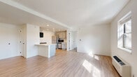 Located at 210 Senate Ave in Camp Hill, PA, this single-floor, 3-bedroom, 2-bathroom residence offers a well-designed layout that maximizes functionality and comfort. The open-concept living and kitchen area serves as the heart of the home, featuring light wood-style flooring that flows seamlessly throughout the main living spaces. Large windows allow natural light to pour in, creating a bright and airy atmosphere.

The kitchen is thoughtfully appointed with gray cabinetry, stainless steel appliances including a refrigerator and microwave, recessed lighting, and a peninsula with a clean white countertop — ideal for casual dining or additional prep space. The living room offers generous proportions, a wall-mounted HVAC unit, and multiple windows that frame views of the surrounding area.

The three bedrooms are comfortably sized, with the primary bedroom offering plush carpeting, a window with natural light, and a wall HVAC unit. The additional bedrooms feature light wood flooring and ample wall space. The two bathrooms are finished in a clean, modern style — one includes a vanity with gray cabinetry and a tub/shower combination with grab bars, while the second features a walk-in shower, also with accessibility hardware. Light wood flooring carries through both bathrooms, reinforcing the cohesive, neutral aesthetic found throughout the entire residence.