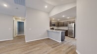 Located at 35 Lucy Ridge Rd in Delaware, Ohio, this single-story home offers a thoughtfully designed layout with two bedrooms, two bathrooms, and a dedicated laundry room. The open-concept kitchen and living area serves as the heart of the home, featuring vaulted ceilings that lend an airy, spacious feel. The kitchen is well-appointed with dark cabinetry, granite countertops, stainless steel appliances including a refrigerator, range, and microwave, and light wood-look flooring that extends throughout the main living areas. The living room is bright and welcoming, with recessed lighting, large windows with blinds, and neutral tones throughout. The primary bedroom provides a comfortable retreat, complete with a walk-in closet fitted with wire shelving. The second bedroom also features plush carpeting, a ceiling fan, a generous closet, and natural light from a large window. Both bathrooms are finished with granite-topped dark vanities and marble-look tile flooring, with the primary bath offering a glass-enclosed shower. The dedicated laundry room includes hookups and built-in shelving. The attached garage offers generous space with an automatic opener. This home combines modern finishes with a clean, functional design.