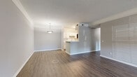 Located at 2840 S Church St in Murfreesboro, TN, this single-floor, one-bedroom, one-bathroom unit offers a well-planned layout with a comfortable sense of space. The open-concept living and dining area is anchored by rich wood-look flooring, crown molding, a textured ceiling, and a pendant light fixture, creating a clean and cohesive aesthetic. A half-wall peninsula separates the living area from the galley-style kitchen, which is outfitted with white cabinetry, a tile backsplash, a double sink, and stainless steel appliances including a range, microwave, and refrigerator — all set on light wood-look flooring.

A standout feature is the bright, bay-windowed nook accessible from the main living area, offering multiple windows with views of the outdoors and a ceiling fan, flooding the space with natural light. The bedroom features plush carpeting, a large window, and access to a dedicated closet, providing a quiet and comfortable retreat. The full bathroom includes a single-sink vanity with modern fixtures and a tub-shower combination. Completing the unit is a dedicated laundry area with a full-size washer and dryer included. Crown molding and consistent neutral tones throughout lend the space a polished, move-in-ready appeal.