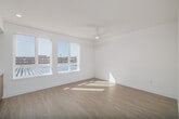 Located at 3585 Aero Ct, Unit 575 in San Diego, California, this efficiently designed one-bedroom, one-bathroom residence offers a clean, modern aesthetic throughout its single floor. Light wood-look flooring flows seamlessly across the space, complemented by crisp white walls and recessed lighting that create a bright, airy atmosphere.

The open-concept living area integrates the kitchen, dining, and living spaces into one cohesive layout. The kitchen is a standout feature, showcasing light wood cabinetry with brushed gold hardware, white quartz countertops, a tiled backsplash, and a full suite of stainless steel appliances including a gas range, built-in microwave, dishwasher, and a large French door refrigerator. Natural light pours in through well-positioned windows, enhancing the inviting feel of the shared living space.

A wide hallway connects the main living area to the private quarters, with access to a dedicated laundry space and a closet for additional storage. The bathroom features a warm wood vanity with a white countertop, a backlit mirror, and a clean, minimalist design with neutral tiling. The bedroom is an intimate, quiet retreat with the same light flooring and neutral palette. The unit's contemporary design and thoughtful layout make efficient use of its footprint throughout.