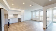 Located on El Cajon Boulevard in San Diego's North Park neighborhood, this modern 2-bedroom, 2-bathroom residence offers a thoughtfully designed, open-concept layout finished with light wood-style flooring and crisp white walls throughout. The combined living, dining, and kitchen area forms the heart of the home, featuring a sleek kitchen with white flat-front cabinetry, a tile backsplash, white quartz countertops, and a full suite of stainless steel appliances including a refrigerator, gas range, microwave, and dishwasher. Recessed lighting illuminates the space, while a glass-panel balcony door opens to an outdoor balcony with open city views. Both bedrooms are well-proportioned, each offering large windows that invite generous natural light and elevated views of the surrounding San Diego skyline. The primary bathroom is appointed with a glass-enclosed walk-in shower accented by decorative tile, built-in shelving, wood-style flooring, and a white vanity with a modern faucet. The second bathroom features a full soaking tub with tiled surround, open shelving, and a matching white vanity. Additional conveniences include three closets, a dedicated laundry area, and a hallway connecting all areas of the home seamlessly.
