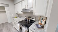 Located at 67 Bluestone Ct in Lakeside Park, KY, this single-floor residence offers 770 square feet of living space across 3 bedrooms and 3 bathrooms. The unit features a consistent neutral gray color palette with white trim throughout, creating a clean and cohesive aesthetic.

The kitchen is a standout feature, boasting white shaker cabinetry, granite countertops, stainless steel appliances, and wood-look luxury vinyl plank flooring. It connects to a dedicated dining room illuminated by a stylish orb-style chandelier with matching LVP flooring. The living room features plush carpeting and a sliding glass door providing access to an outdoor balcony with natural views.

The primary bedroom measures 150 square feet and includes a walk-in closet with a built-in clothing rod. All three bedrooms feature soft carpeting and neutral gray walls. The bathrooms are finished with LVP flooring, white vanities with white countertops, and clean white shower surrounds. Two hallways connect the space efficiently.

The unit maintains a uniform design language with textured ceilings in select rooms, white six-panel doors, and ample electrical outlets. The overall ambiance is bright, neutral, and move-in ready.