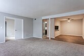 Located in Marietta, Georgia, this single-story residence at 1981 Hidden Glen Dr SE offers a practical and comfortable layout designed for everyday living. The interior is finished in a consistent neutral gray palette throughout, creating a cohesive and clean ambiance across all rooms.

The living area is generously proportioned, featuring plush wall-to-wall carpeting, a textured ceiling, and a window that invites natural light into the space. Multiple bedrooms continue the carpeted flooring theme, each offering closet storage and windows with blinds that provide views of the surrounding greenery. One room features wood-look plank flooring and a ceiling fan with light fixture, adding both style and functionality.

The kitchen is well-appointed with dark espresso cabinetry, speckled countertops, a double-basin stainless steel sink, and black appliances including a refrigerator and dishwasher, all set atop wood-look flooring. Two bathrooms serve the home — a full bath complete with a tiled tub-shower combination, dark vanity cabinetry, and speckled countertops, and a second bathroom featuring a streamlined vanity with a white countertop and wood-look flooring. Throughout the home, clean white trim and neutral walls provide a versatile backdrop ready for personalization.