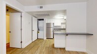 Located at 15082 N 59th Ave in Glendale, Arizona, this well-designed one-bedroom, one-bathroom residence offers a smart and functional layout across a single floor. Light-toned wood-look flooring runs throughout, creating a cohesive and clean aesthetic from room to room.

The kitchen is a standout feature, outfitted with crisp white cabinetry, grey countertops, and a full suite of stainless steel appliances including a refrigerator and dishwasher. A peninsula provides additional prep and dining space, while a built-in flush ceiling light keeps the area bright. Notably, an in-unit stacked washer and dryer is tucked neatly into a dedicated closet just off the kitchen, adding exceptional convenience.

The living area is open and airy, benefiting from natural light and a clean, neutral palette that makes the space feel welcoming. The bedroom is comfortably sized, featuring a ceiling fan, window with blinds, and direct access to a walk-in closet complete with built-in shelving and hanging rods for ample storage.

The bathroom is clean and straightforward, featuring a full soaking tub with an overhead shower, chrome fixtures, and bright white surroundings. Throughout the unit, white walls and trim contribute to a fresh, move-in-ready feel well suited for comfortable single-occupant living in the Glendale area.