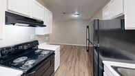 Located at 315 Amesbury Dr in Lafayette, Louisiana, this one-bedroom, one-bathroom unit offers a practical and comfortable single-floor layout. The open-concept main area seamlessly integrates the living room, dining space, and kitchen, creating an efficient and inviting environment. Plush carpet covers the living and dining zones, while wood-look vinyl plank flooring runs through the kitchen and bathroom, providing a clean contrast throughout the space.

The galley-style kitchen is well-equipped with white cabinetry offering ample storage, a black refrigerator, an electric range, and an under-cabinet range hood. A dedicated pantry provides additional storage convenience. The kitchen opens directly into the dining and living area, making the layout ideal for everyday functionality.

The bedroom is a comfortable, well-proportioned room featuring carpet flooring, a ceiling fan with light fixture, a window with blinds that allows natural light, and a closet with built-in wire shelving for organized storage. Ceiling fans with integrated lighting are present throughout the unit, aiding in air circulation.

The bathroom includes a full tub-shower combination, vanity with white cabinetry, and wood-look flooring. A textured ceiling is consistent throughout the unit, and neutral warm-gray walls create a cohesive, understated aesthetic across all rooms.