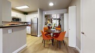 Located at 1155 W Grove Pkwy in Tempe, Arizona, this 2-bedroom, 2-bathroom single-floor residence offers a thoughtfully designed layout that maximizes functionality and comfort. The kitchen features white cabinetry, dark countertops, and a full suite of stainless steel appliances — including a gas range, built-in microwave, and dishwasher — all complemented by wood-look tile flooring and a bright window. The combined living and dining area provides an open, connected feel, with wood-look flooring throughout, a ceiling fan, and large patio doors that invite natural light. A mirrored wall accent in the dining space adds depth to the room. The in-unit laundry is conveniently tucked away nearby. Both bedrooms are carpeted and equipped with ceiling fans, offering a cozy retreat. The primary bedroom includes a dedicated walk-in closet with built-in wire shelving. The bathrooms feature tub-shower combinations with clean, white surrounds. Throughout the home, generous closet and storage options — including six closets total — ensure ample organization. A private patio and a utility room round out the offerings of this practical and comfortable Tempe residence.