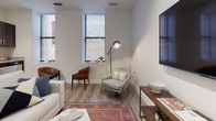 Located at 405 W Redwood Street in downtown Baltimore, this thoughtfully designed single-floor residence offers a cohesive blend of modern finishes and functional layout. The living area serves as the heart of the space, featuring light wood-style flooring, neutral walls, and natural light streaming through tall, slim windows framed in black — offering views of the surrounding brick urban streetscape. The open, airy feel is complemented by a wall-mounted television and versatile seating arrangements. The kitchen is efficiently designed with rich dark-stained cabinetry, granite-style countertops, and a full suite of stainless steel appliances including a range, over-the-range microwave, and dishwasher, all set against light hardwood-style flooring. The bedroom is a calm retreat, finished in soft neutral tones with plush carpeting and ample wall space, creating a serene and restful environment. The full bathroom continues the home's clean aesthetic, featuring light wood-style tile flooring, dark vanity cabinetry with a white countertop, and a glass-enclosed shower and tub combination with polished chrome fixtures. Throughout the space, consistent finishes and a neutral color palette create a unified, contemporary atmosphere.