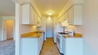 Located at 45600 Fox Ln W in Shelby Township, Michigan, this single-floor residence offers a well-organized layout with clearly defined living spaces. The galley-style kitchen is efficiently designed with white cabinetry lining both walls, warm countertops, tile flooring, a gas range, refrigerator, and a built-in sink — providing ample storage and workspace for everyday cooking. Adjacent to the kitchen, the living area features soft carpeting and an open connection to the rest of the unit, creating a comfortable and functional flow. The bedrooms are carpeted and filled with natural light courtesy of large windows fitted with vertical blinds, offering pleasant outdoor views of the surrounding greenery. Each bedroom includes closet access, and the primary bedroom connects directly to a private bathroom. The bathrooms are finished with tile flooring, vanity cabinetry with warm countertops, a large mirror, and classic white fixtures. Throughout the space, neutral wall tones and clean lines contribute to a bright, understated ambiance. The single-floor layout ensures easy accessibility and efficient use of space, making this residence a practical and comfortable option in the Shelby Township area.