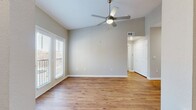 This 720 square foot apartment in Oklahoma City offers a thoughtful layout that maximizes space and functionality. The single-floor design includes one bedroom, one bathroom, and an open-concept kitchen and living area. The primary bedroom, measuring 140 square feet, features plush carpeting and a large window, providing a cozy retreat.

The apartment boasts modern finishes throughout, with gleaming hardwood floors in the main living areas and kitchen. The bathroom showcases a sleek design with a white vanity, large mirror, and a combination shower/tub. The kitchen is a highlight, featuring crisp white cabinetry, stainless steel appliances, and a hexagonal tile backsplash. A central island adds extra counter space and storage.

Large windows and French doors in the living area flood the space with natural light and offer access to a small balcony. A unique glass block feature wall adds architectural interest. The apartment also includes a closet for additional storage and two hallways for easy navigation. Ceiling fans in multiple rooms provide comfort and air circulation. Overall, this apartment combines style and efficiency in a compact, well-designed space.