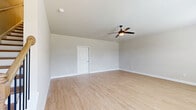 Located at 617 Garfield Ave in McDonough, Georgia, this well-appointed three-floor home offers three bedrooms and four bathrooms across a thoughtfully designed layout. The ground level features an attached garage with a concrete floor, electrical panel, and interior access. The main living level showcases an open-concept kitchen and living area, where white shaker cabinetry, granite countertops, a subway tile backsplash, and stainless steel appliances create a clean, contemporary kitchen. Light hardwood-style flooring runs throughout, complementing the neutral, soft-gray walls and crisp white trim found across the home. The upper floor houses the bedrooms, including a generously sized primary suite with a walk-in closet featuring full-length hanging rods and a private en-suite bathroom complete with a soaking tub, glass-enclosed shower, and granite vanity. Additional bedrooms are bright and airy, each with ceiling fans and windows that invite natural light and outdoor views. A dedicated laundry room with a side-by-side washer and dryer adds everyday convenience. With four bathrooms, ample closet storage, and a flowing multi-level layout, this home offers a comfortable and functional living experience.