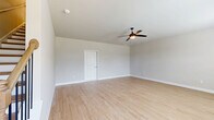 Located at 617 Garfield Ave in McDonough, Georgia, this well-appointed three-floor home offers three bedrooms and four bathrooms across a thoughtfully designed layout. The ground level features an attached garage with a concrete floor, electrical panel, and interior access. The main living level showcases an open-concept kitchen and living area, where white shaker cabinetry, granite countertops, a subway tile backsplash, and stainless steel appliances create a clean, contemporary kitchen. Light hardwood-style flooring runs throughout, complementing the neutral, soft-gray walls and crisp white trim found across the home. The upper floor houses the bedrooms, including a generously sized primary suite with a walk-in closet featuring full-length hanging rods and a private en-suite bathroom complete with a soaking tub, glass-enclosed shower, and granite vanity. Additional bedrooms are bright and airy, each with ceiling fans and windows that invite natural light and outdoor views. A dedicated laundry room with a side-by-side washer and dryer adds everyday convenience. With four bathrooms, ample closet storage, and a flowing multi-level layout, this home offers a comfortable and functional living experience.
