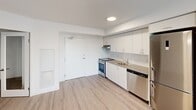 This one-bedroom, one-bathroom unit at 375 South Street in London, Ontario offers a clean, modern design with a practical and efficient layout across a single floor. The open kitchen is outfitted with white cabinetry extending to the ceiling for ample storage, a grey countertop with an undermount sink, and a full suite of stainless steel appliances including a refrigerator, electric range, and dishwasher. Light wood-style flooring runs throughout the main living areas, contributing to a bright and cohesive aesthetic. A large window at the end of the kitchen area allows natural light to filter through, enhancing the sense of openness. The bedroom is a well-proportioned, private space featuring the same light flooring, crisp white walls, and a clean, minimalist finish with ample room for furnishings. The four-piece bathroom is finished in white, featuring a full-size soaker tub with an overhead shower, a toilet, a vanity with storage, and an additional wall-mounted cabinet for convenience. The unit also includes an unclassified room, suitable for use as a den, office, or storage space. Overall, the unit presents a bright, modern, and move-in-ready living space in a well-located London neighbourhood.