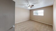 Located at 7125 S Santa Fe Ave in Oklahoma City, Oklahoma, this single-story home offers a practical and comfortable layout across two bedrooms and one full bathroom. The kitchen is equipped with dark cabinetry, a double-basin sink, white appliances including a full-size refrigerator, and light tile flooring, providing a functional space for everyday cooking. A textured ceiling adds a classic residential touch throughout the home. Both bedrooms feature warm neutral-toned walls, plush carpet flooring, and windows that allow natural light to fill each room. The primary bedroom is generously sized and includes a ceiling fan with integrated lighting, as well as dedicated closet storage. The second bedroom similarly offers carpeted floors, a ceiling fan, and a window with exterior views. A connecting hallway provides access to the full bathroom, which includes a soaking tub set within a tile-surround enclosure, light flooring, and a vanity with dark cabinetry. Two closets throughout the home offer ample storage solutions. The overall ambiance is clean, neutral, and move-in ready, making it a straightforward and functional residential space suited for everyday living.