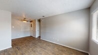 Located at 1610 E McKinney St in Denton, Texas, this single-floor unit offers a practical and well-maintained layout designed for comfortable everyday living. The main living area features durable wood-look flooring and neutral gray walls, creating a clean, versatile backdrop. A ceiling fan adds comfort to the space, while windows fitted with blinds allow for natural light and outdoor views. The living area flows conveniently toward the entryway, which includes an exterior door with a decorative glass insert.

The galley-style kitchen is efficiently arranged, featuring white cabinetry, gray subway tile backsplash, laminate countertops, a stainless steel sink, and black appliances including a refrigerator, electric range, and dishwasher. The layout maximizes available counter and storage space.

The bedrooms are finished with plush carpet flooring and textured ceilings, offering a quieter and softer environment. Each bedroom is brightened by windows with views to the outdoors. Neutral tones throughout maintain a cohesive and move-in-ready aesthetic.

The bathroom is outfitted with a full soaking tub and shower combination, elegantly surrounded by taupe subway tile that extends from the tub deck to the ceiling. White cabinetry provides additional storage. Overall, the unit presents a clean, updated interior with consistent finishes throughout.