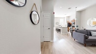 Located in Orlando's Baldwin Park neighborhood, this 2-bedroom, 1-bathroom residence offers a well-designed open-concept layout. Light wood-style flooring flows continuously throughout the space, creating a cohesive and airy feel. The entryway leads into a spacious living area that opens seamlessly into the kitchen and dining zones. The kitchen is a standout feature, equipped with warm wood cabinetry, granite countertops, stainless steel appliances including a refrigerator, range, microwave, and dishwasher, and a large center island with bar seating. Multiple windows along the kitchen wall flood the space with natural light and provide views of the outdoors. A separate dining area with pendant lighting complements the open layout. The primary bedroom is generously sized, featuring large windows that invite natural light, and is accompanied by a well-appointed bathroom with a wood-toned vanity, white quartz countertop, and a glass-enclosed tiled shower. The second bedroom also benefits from natural light through tall windows. Additional highlights include a dedicated closet and a living area with open shelving, lending the home both style and functional storage throughout.