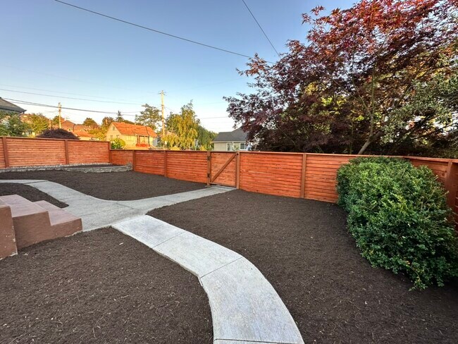 We'll be adding plants to the freshly mulched low-maintenance yard. - 606 9th St