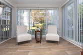 This single-floor residence on Summerwood Drive in Clarkston, Georgia offers a well-organized layout with comfortable living spaces throughout. The living room serves as the heart of the home, featuring a classic fireplace with a dark marble surround, hardwood-style flooring, and large sliding glass doors that open to an outdoor patio, filling the space with natural light and providing views of the surrounding greenery. An additional window further brightens the room, creating an airy and welcoming atmosphere.

The kitchen is equipped with white cabinetry, speckled stone countertops, and a black gas range, complemented by light hardwood-style floors. A louvered bifold door leads to a dedicated laundry area conveniently located within the kitchen space.

The two bedrooms are carpeted and well-proportioned, each offering a calm, neutral palette. One bedroom benefits from a window with exterior views, while both provide comfortable retreats with ample room for furnishings.

Two bathrooms mirror each other in design, each featuring a single-basin vanity with speckled countertops, a large mirror, brushed nickel fixtures, and a shower-tub combination with a curtain. The textured walls throughout the bathrooms add a subtle dimensional quality to the finishes.