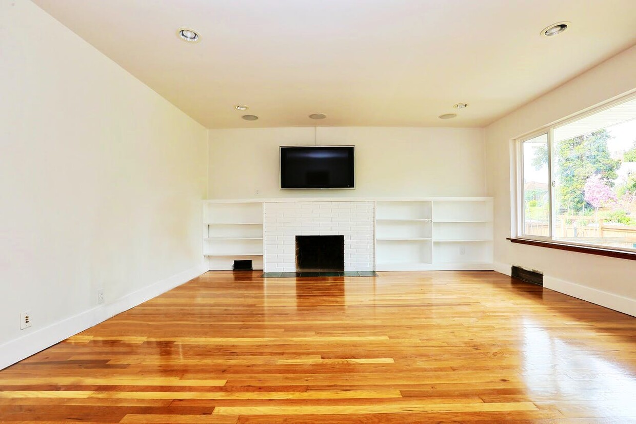 Gorgeous hardwood flooring flows throughout the bright living area! - 4128 14th Ave S