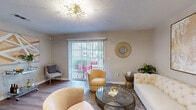 This well-appointed single-story residence in Walls, Mississippi offers two bedrooms and two full bathrooms within a thoughtfully designed floor plan. The living room serves as the heart of the home, featuring wood-look flooring, neutral warm-toned walls, and a striking sputnik chandelier that adds a contemporary touch. A sliding glass door floods the space with natural light and provides direct access to a private outdoor area. A dedicated dining space sits adjacent to the living room, illuminated by a modern circular pendant light.

The galley-style kitchen is outfitted with white cabinetry, quartz countertops, and a full suite of appliances including a refrigerator and dishwasher. A convenient in-unit laundry area connects directly to the kitchen. Both bedrooms feature plush carpeting and decorative pendant lighting, offering a comfortable and relaxing atmosphere. Each bathroom includes quartz-topped vanities and tub-shower combinations with hardwood-look flooring. The consistent use of neutral tones and modern gold accents throughout creates a cohesive, contemporary aesthetic across the entire residence.