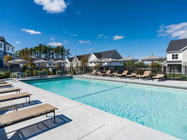 Take a dip or lounge poolside—this expansive outdoor pool offers plenty of space to unwind under the sun. - Modera South Shore