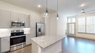 Located at 176 College Park Dr in Weatherford, TX, this single-story, 3-bedroom, 2-bathroom home offers a well-designed layout with modern finishes throughout. The open-concept living, dining, and kitchen area serves as the heart of the home, featuring warm wood-look flooring, recessed lighting, and large windows that invite abundant natural light. A ceiling fan adds comfort to the airy living space, which opens to a private patio. The kitchen is appointed with granite countertops, a center island with pendant lighting, gray shaker cabinetry, white subway tile backsplash, and a full suite of stainless steel appliances. Three bedrooms provide comfortable accommodations, with the primary bedroom offering dual closets and generous proportions. A spacious walk-in closet with built-in shelving and hanging rods adds exceptional storage. The home includes six closets in total, ensuring ample organization throughout. Both bathrooms showcase marble-look tile, granite vanity countertops, and quality fixtures — one featuring a soaking tub and shower combination, the other a glass-enclosed walk-in shower. A dedicated laundry area and a connecting hallway complete this thoughtfully arranged home.