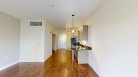 Located at 8901 N Chestnut Ave in Kansas City, MO, this one-bedroom, one-bathroom unit offers a well-designed layout across a single floor. The kitchen is a standout feature, equipped with stainless steel appliances including a full-size refrigerator, electric range, built-in microwave, and dishwasher. Light wood-toned cabinetry pairs elegantly with dark granite countertops and a double stainless steel sink, while rich hardwood-style flooring ties the space together. Track lighting and crown molding add a polished finish, and a set of glass panel doors invites natural light into the living area. The bathroom continues the refined aesthetic with matching light wood cabinetry, dark granite countertops, and clean tile flooring, offering a cohesive design throughout. The bedroom provides a comfortable and functional private retreat. A notable bonus is the attached private garage, featuring a concrete floor, overhead door, and direct interior access — offering valuable storage or secure parking. The overall design balances modern finishes with practical functionality, making this a well-appointed unit in Kansas City.
