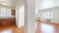 Located at 437 N Ardmore Ave in the heart of Los Angeles, this one-bedroom, one-bathroom unit offers a well-organized layout across a single floor. Warm hardwood flooring flows consistently throughout the space, creating a cohesive and inviting atmosphere.

The living room is bright and open, featuring textured white walls, a wall-unit heater, mirrored closet doors that enhance the sense of space, and a window fitted with blinds that allows natural light to filter in. Adjacent to the living area, the kitchen is well-equipped with rich walnut-toned cabinetry, granite countertops, a stainless steel gas range, a full-size refrigerator, and a window above the sink that brings in additional natural light.

The bedroom is a comfortable, sunlit retreat featuring two windows with blinds, a ceiling fan, and clean white walls. It connects seamlessly to the rest of the unit via a hallway.

The bathroom is finished with classic white subway tile surrounding a full soaking tub, a white vanity, and a window that provides natural ventilation and light. The overall aesthetic throughout the unit is clean, minimal, and functional, making it a practical home in a prime Los Angeles location.