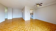 Located at 62 Park Ave in Halton Hills, Ontario, this 2-bedroom, 1-bathroom unit offers a practical and well-organized single-floor layout. Warm parquet flooring runs consistently throughout the main living areas and bedrooms, lending a classic character to the space.

The open living room is generously proportioned, featuring a ceiling fan and large sliding glass doors that lead to a private balcony with open views of the surrounding neighbourhood. Natural light fills the room, creating a bright and welcoming atmosphere. The adjacent kitchen is connected via an open passageway and is equipped with white cabinetry and appliances, including a range with oven, complemented by tile flooring.

Both bedrooms are comfortably sized and each includes a sliding-door closet for ample storage. The primary bedroom benefits from a large window that draws in natural light and features a baseboard heating unit. The second bedroom is similarly appointed with parquet flooring and a double closet.

The bathroom is finished with neutral ceramic wall tiles and includes a full soaker tub with a handheld showerhead and a safety grab bar, offering both comfort and accessibility.

Overall, the unit presents a clean, functional layout suited for a variety of lifestyles, in a well-established Halton Hills location.
