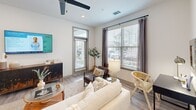 Located at 2311 Odell School Rd in Charlotte, NC, this thoughtfully designed 2-bedroom, 2-bathroom residence offers a modern aesthetic across a single floor. The open-concept kitchen is a standout feature, showcasing light wood cabinetry, stainless steel appliances, subway tile backsplash, and a spacious island with quartz-style countertops and bar seating — ideal for both cooking and casual dining. Light wood-style flooring flows throughout, lending warmth and continuity to the space.

The living room is bright and inviting, featuring large windows with horizontal blinds and drape panels that fill the room with natural light, complemented by a ceiling fan overhead. The primary bedroom is a comfortable retreat with a wide window, ceiling fan, and clean white walls, while the second bedroom features a bold teal accent wall that adds a distinctive design touch.

Both bathrooms are well-appointed: the primary bath includes a walk-in glass shower, vanity with under-sink storage, and wall-mounted cabinetry, while the second bath offers a full shower-tub combination. A central hallway connects all rooms efficiently. The overall design emphasizes clean lines, neutral tones, and functional layouts, making this Charlotte residence a polished and practical home.