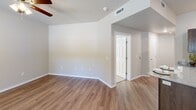 Located at 1143 E Sain St in Fayetteville, Arkansas, this single-story, 3-bedroom, 3-bathroom home offers a practical and comfortable layout designed for everyday living. The combined kitchen and living area serves as the heart of the home, featuring warm hardwood-style luxury vinyl plank flooring, recessed lighting, and a well-appointed kitchen outfitted with dark espresso cabinetry, granite-style countertops, a stainless steel refrigerator, electric range, and built-in microwave. The bedrooms provide a mix of flooring options — two feature plush carpeting with ceiling fans and natural light from window blinds, while the primary bedroom includes hardwood-style flooring and a ceiling fan. Each bedroom is complemented by a walk-in closet with wire shelving systems for organized storage. The three bathrooms are finished with dark wood vanities, white countertops, and tub/shower combinations with sliding glass doors and hardwood-style flooring. Neutral tones and clean finishes throughout the home create a cohesive, move-in-ready atmosphere well-suited for residents seeking a functional and low-maintenance living space in Fayetteville.