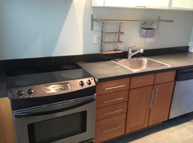 galley kitchen with stainless appliances - 142 Humboldt Ave
