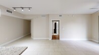 This contemporary 3-bedroom, 2-bathroom residence in Delray Beach, Florida, offers 1140 square feet of thoughtfully designed living space. The single-story layout promotes easy navigation and accessibility. Upon entering, you're greeted by a bright, open-concept living area with sleek tile flooring and a modern ceiling fan, creating an inviting atmosphere. The updated kitchen boasts dark wood cabinetry, stainless steel appliances, and granite countertops, perfect for culinary enthusiasts. Large windows throughout the home allow ample natural light, while providing views of the surrounding palm trees, adding to the tropical Florida ambiance. The bedrooms feature warm hardwood floors and sizable windows, with the primary bedroom measuring a comfortable 160 square feet. Both bathrooms are well-appointed with modern fixtures, including a glass-enclosed shower in one and a tub-shower combination in the other. The neutral color palette throughout the home offers a blank canvas for personalization. With its blend of style and functionality, this Delray Beach property presents an ideal setting for comfortable family living or as a serene getaway in the Sunshine State.