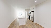 Located at 4806 Oakwood Ave in the heart of Los Angeles, this thoughtfully designed single-floor unit offers a clean, modern aesthetic defined by crisp white walls, recessed lighting, and warm light wood flooring that runs throughout. The open-concept kitchen serves as the centerpiece of the living area, anchored by a generous island with a sleek quartz countertop, an undermount sink, and stainless steel fixtures. The kitchen is fully equipped with white flat-front cabinetry, a gas range, built-in microwave, and a stainless steel French door refrigerator, all complemented by a neutral tile backsplash. The layout flows seamlessly into the open living area, which is bathed in natural light. The bedrooms are bright and well-proportioned, each featuring large windows that draw in abundant sunlight, light wood flooring, and recessed lighting. One bedroom includes a built-in closet with shelving and hanging space. The bathroom is finished with large-format tile flooring, a full soaking tub with a tiled surround, and a vanity with clean-lined cabinetry. The overall ambiance is modern, minimal, and move-in ready, reflecting a cohesive design sensibility throughout.