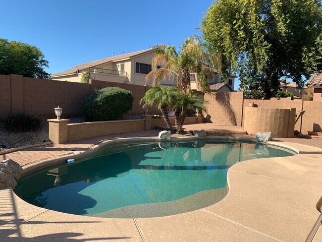 Spacious 4-bedroom, 2-bath home with soaring ceilings, gourmet kitchen, and a heated self-cleaning p - 16426 N 152nd Ln