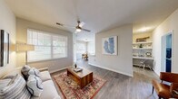 Located at 4265 Millbrook Green Dr in Raleigh, NC, this single-floor home offers four bedrooms, two bathrooms, and a well-organized layout designed for comfortable living. An elegant entryway with an arched passage and warm neutral tones sets the tone for the rest of the home, welcoming residents into a bright and cohesive interior.

The living room features hardwood-style flooring, a ceiling fan, and large windows fitted with white blinds that allow ample natural light to fill the space. An open sightline connects the living area to the dining nook, which benefits from its own large window overlooking lush greenery outside. The galley-style kitchen is well-appointed with white cabinetry, granite countertops, stainless steel appliances, and abundant storage.

The primary bedroom is generously sized and accompanied by a closet with built-in wire shelving. The bathrooms are finished with granite-topped vanities, white cabinetry, and brushed nickel hardware. A dedicated in-unit laundry room houses a full-size washer and dryer, adding everyday convenience. Throughout the home, consistent use of hardwood-style flooring, soft neutral paint tones, and clean white trim create a cohesive and modern aesthetic.