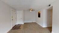 Located at 260 E Reynolds Rd in Lexington, Kentucky, this single-floor unit offers a practical and comfortable layout designed for everyday living. The expansive living area is finished with neutral-toned carpet and crisp white walls, illuminated by a ceiling fan light fixture overhead and a textured ceiling throughout. A pass-through window connects the living space to the kitchen, enhancing the open feel of the floor plan. French doors in the living room provide natural light and easy access to the outdoors.

The kitchen is outfitted with rich, dark espresso cabinetry paired with granite-style countertops, a stainless steel double-basin sink with a pull-down faucet, and a black dishwasher — offering both style and functionality in a compact, efficient layout.

Two well-sized bedrooms feature plush carpeting, neutral walls, and windows that allow natural light to filter in, creating a calm and restful atmosphere in each room. The bathroom is clean and straightforward, featuring a full-size soaking tub with shower combination, a toilet, and a dark-cabinet vanity, all set on wood-look flooring that adds a warm contrast to the bright white fixtures. The overall design is clean, neutral, and move-in ready.