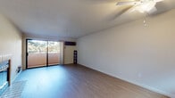 This single-floor residence offers a thoughtfully laid-out interior with a variety of functional spaces. The living area is generously proportioned, featuring light wood-tone flooring, clean white walls, and a textured ceiling. A wall-mounted HVAC unit provides climate control, while a sliding glass door opens to a private balcony with outdoor views of surrounding greenery, allowing natural light to fill the room.

The galley-style kitchen is efficiently designed with light wood cabinetry, granite-look countertops, and stainless steel appliances including a full-size refrigerator and dishwasher. Light hardwood-style flooring continues throughout this space, creating a cohesive aesthetic.

The bedrooms feature plush carpeting and mirrored sliding closet doors that enhance the sense of space. Windows frame views of neighboring trees, and a baseboard heating unit ensures comfort year-round.

The bathrooms are finished with light wood vanity cabinetry, granite-look countertops, and a tub and shower combination enclosed by sliding frosted glass doors. Tile flooring and a well-placed mirror above the vanity complete the clean, functional design. Overall, the unit presents a bright, neutral palette throughout.