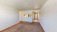 Located at 1336 Birch Tree Ln in Traverse City, Michigan, this two-bedroom, two-bathroom single-floor unit offers a functional and well-organized layout across a comfortable footprint. The living room serves as the central gathering space, featuring plush carpeting, a textured ceiling, and a large window that fills the room with natural light and provides outdoor views. Tile flooring at the entryway transitions seamlessly into the carpeted living area.

The kitchen is equipped with warm wood-toned cabinetry, a white electric range, refrigerator, and a built-in range hood. A convenient in-unit laundry closet is located just off the kitchen, housing a full-sized washer and dryer. Light tile flooring runs throughout the kitchen and both bathrooms.

Both bedrooms are carpeted and feature large windows — one overlooking a wooded backdrop and the other with views of the surrounding neighborhood. The primary bedroom includes two closets with bi-fold doors and direct access to one of the full bathrooms. Each bathroom is fitted with a wood-toned vanity, tile flooring, a tub-shower combination, and a mirrored vanity light above the sink. A hallway connects the main areas of the unit, completing this practical and comfortable layout.